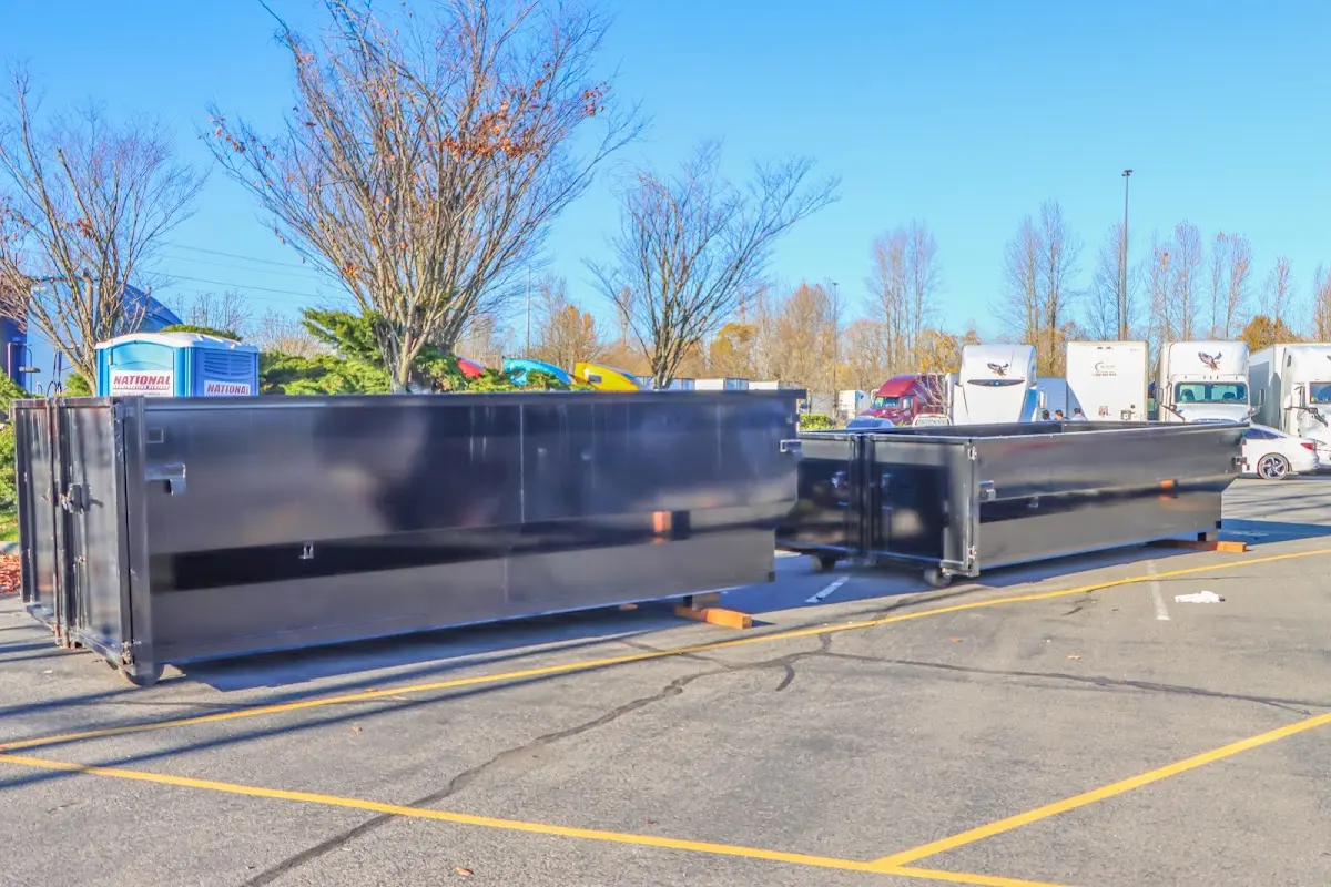 Professional dumpster rental service with roll-off container on residential driveway in Coon Rapids